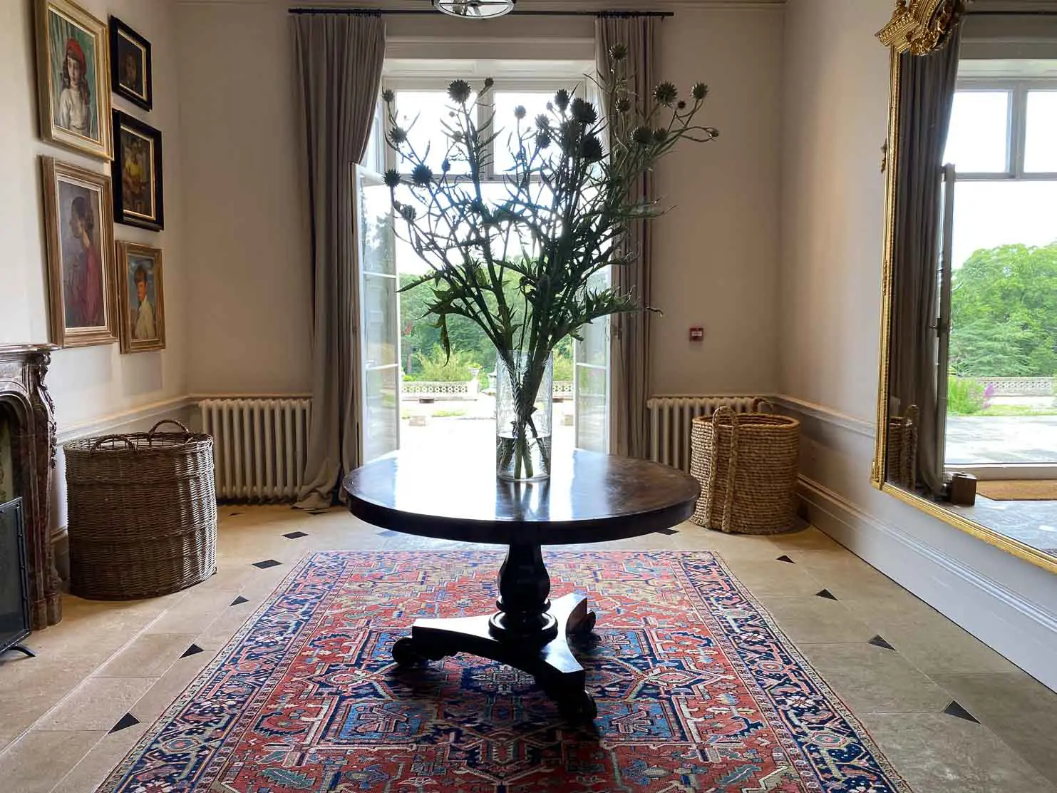 Heckfield Place The entrance hall at Heckfield Place. On one side of the wall are beautiful portraits and on the opposing side, a massive mirror which doubles up the space