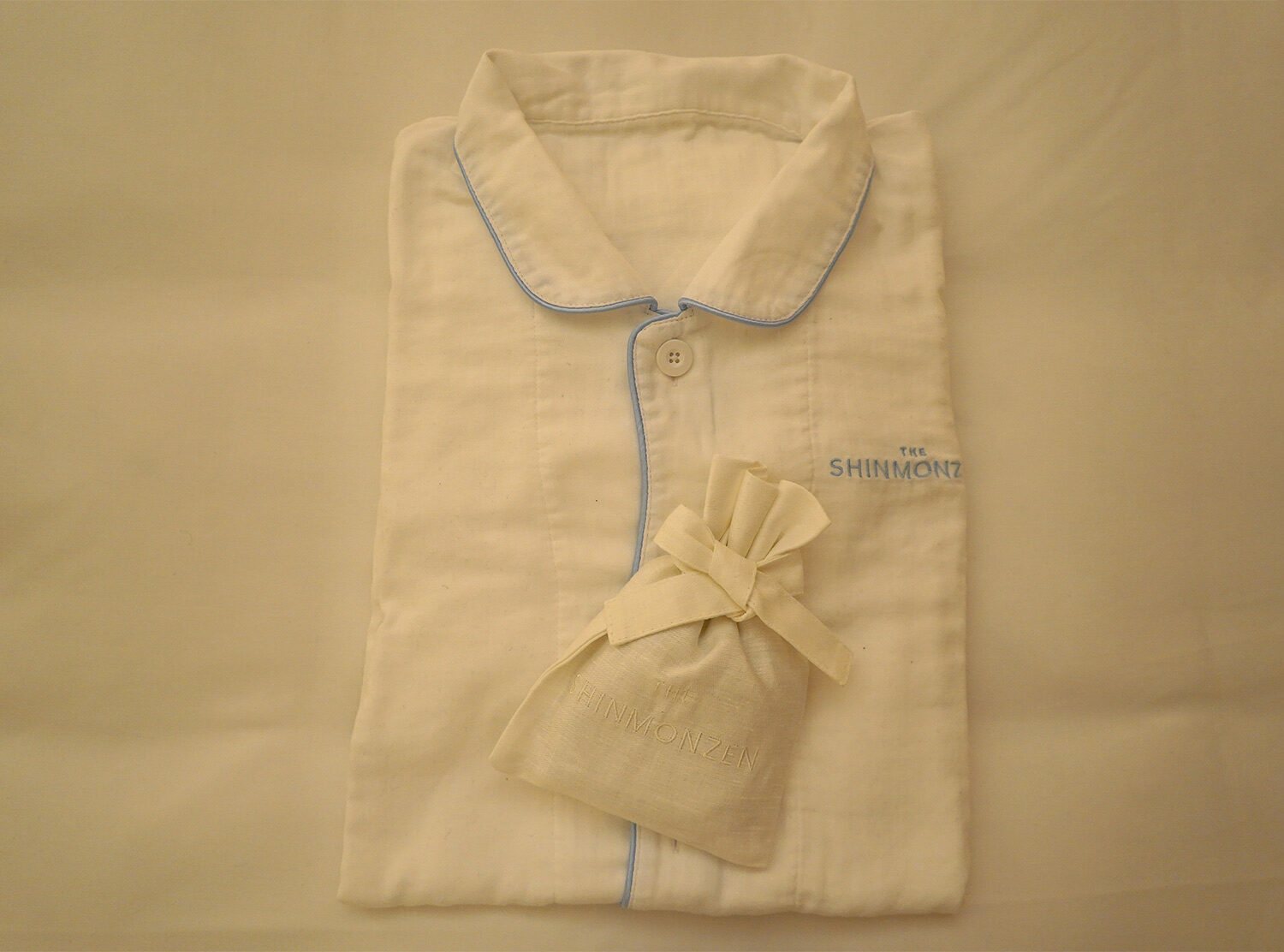 The Shinmonzen Cozy, his and her pajamas delicately placed on our bed, unexpected and charming