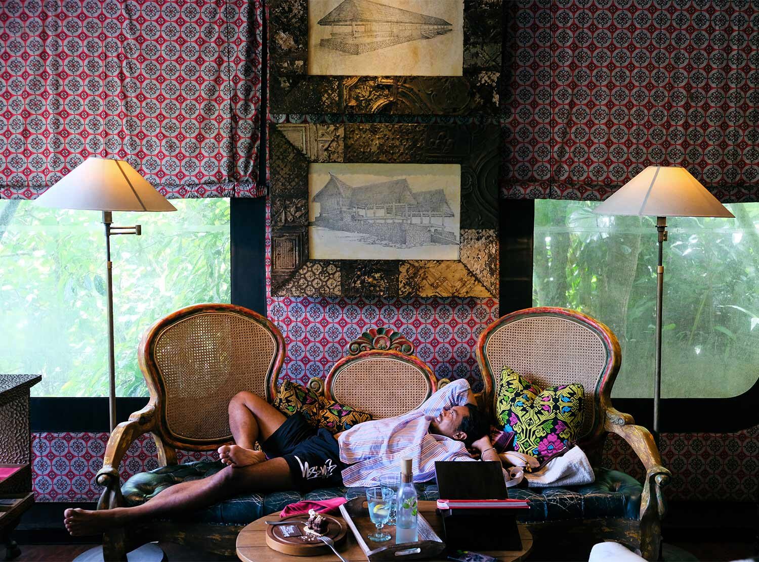 Capella Ubud Each tent goes by the name of a profession found during the 1900s. Our tent's name was Architect, and it featured old blueprint drawings and carved doors and windows as decoration. The colorful fabric hugging the space is a feast for the eye, especially during morning hours, with soft light illuminating the red, making you wake up in a glow