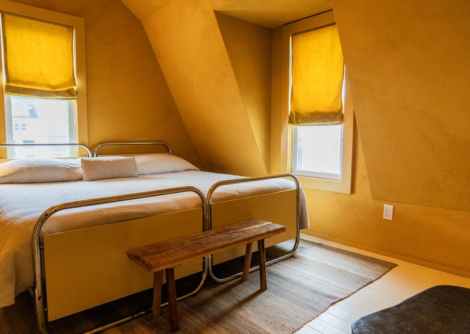 The James Bradley An explosion of color: Marcel Breuer-style beds in this golden yellow room