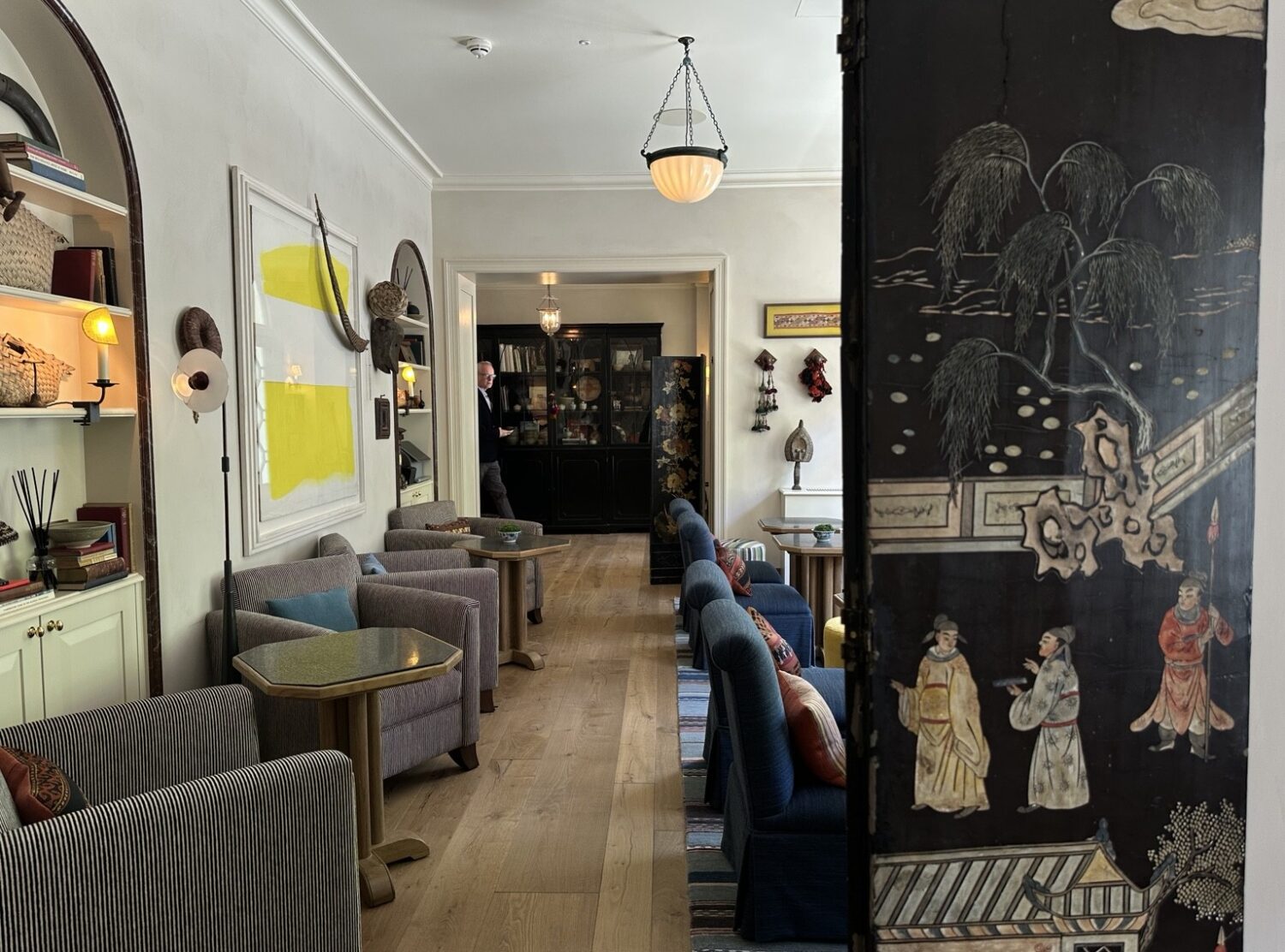 The Zetter Bloomsbury Lobby corners layered with books, objects, masks, textiles, and just enough eccentricity.
