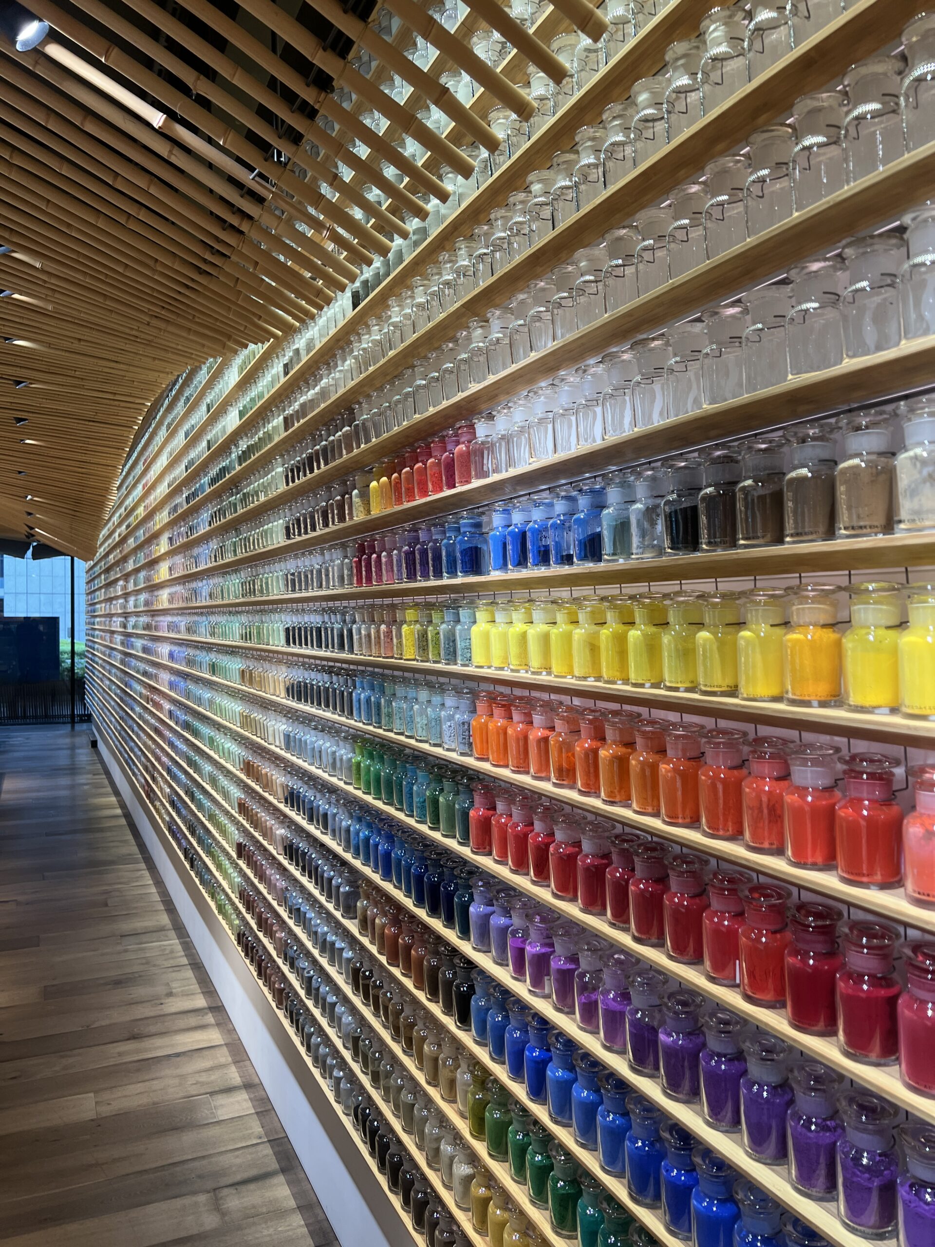 A rainbow wall of pigments inside PIGMENT TOKYO