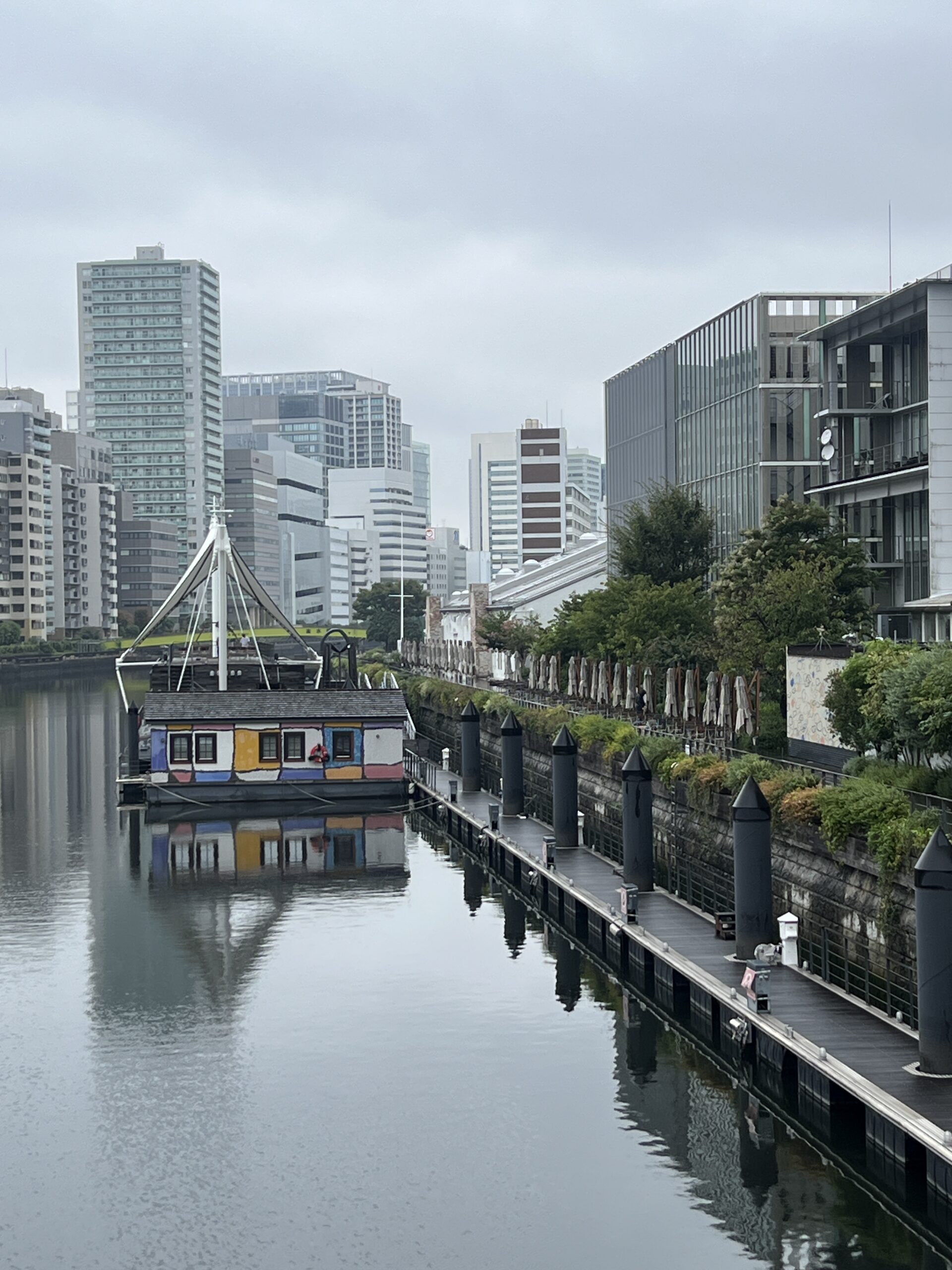 A quiet stretch of the Tennozu Canal, with one of PETALS TOKYO’s colorful floating hotel rooms in the distance